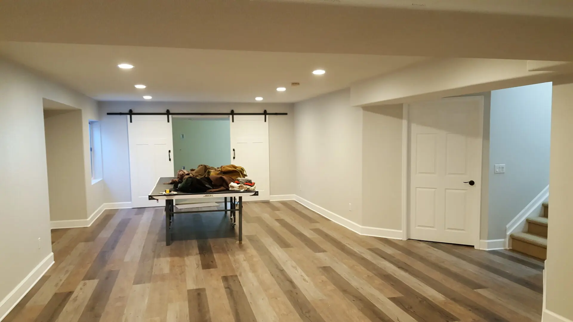 A room with wood floors and white walls.